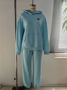 Detail of light blue hoodie set with red heart embroidery and kangaroo pocket