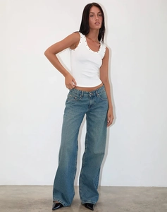 Professional model shot showcasing white ribbed tank top with silver eyelet neckline detail