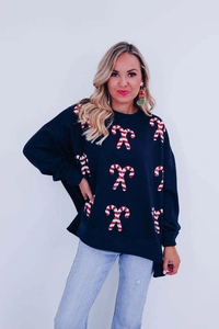 Detail of the high-quality candy cane embroidery on this festive oversized women sweater