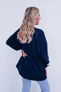 Detail of oversized dark blue sweatshirt with relaxed fit and dropped shoulder design