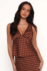 Close-up of brown polka dot satin top with delicate lace trim on the V-neckline