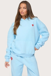 Detail of light blue fleece tracksuit with red heart logo on hoodie and joggers