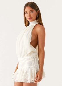 Detail of white crochet knit halter dress showing hollow texture and waist structure