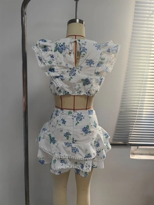 Detail of floral two-piece set with pompom trim and layered ruffle skirt back view