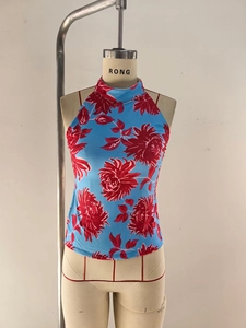 Detail of sky blue halter top with large red chrysanthemum print and high neckline