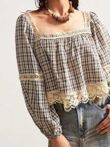Detail of square neckline with delicate beige floral lace trim on plaid short sleeve top