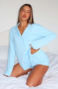 Detail of light blue long-sleeve button-down pajama set with matching elastic shorts