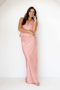 Detail of elegant pink satin two-piece set featuring lace trim V-neck top and floor-length skirt