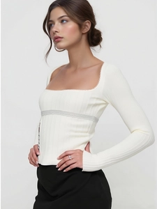 Detail of square neckline with delicate lace trim on cream long-sleeve knit top