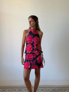 Detail of floral halter top and skirt set showing blue drawstring ties and vibrant print