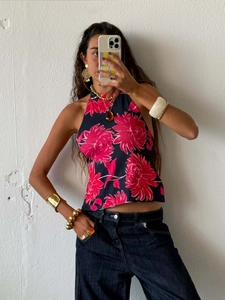 Close-up of halter neck top with vibrant red floral print and slim fit design