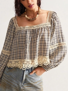 Detail of bohemian plaid shirt showing beige crochet lace trim on neck and sleeve cuff