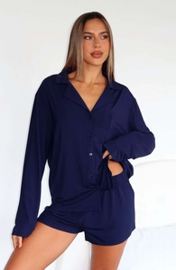 Detail view of navy blue long sleeve pajamas shirt with buttons and chest pocket texture