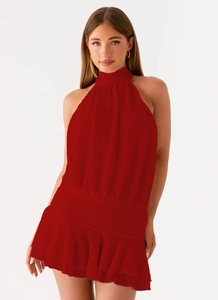 Detail of red knit halter top featuring hollow out texture and ruffled hemline
