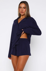 Detail of navy blue long-sleeve pajama set with notch collar and chest pocket