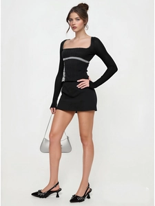 Detail of square neckline long sleeve top with grey striped trim and mini skirt