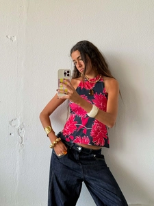 Detailed halter neck floral top with deep blue and pink patterns and asymmetric hem