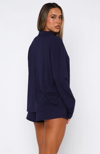 Detail view of the soft navy blue long sleeve pajama top and shorts set for home