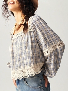 Detail of blue plaid blouse with white lace trim and breathable cotton linen texture