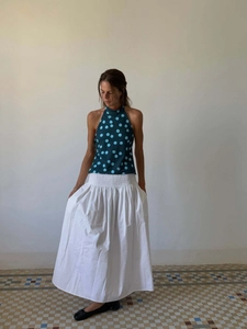 Detailed close-up of halter top with polka dots and high waist elastic skirt waist