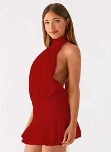 Close-up of red knit halter dress featuring crochet texture and backless design details