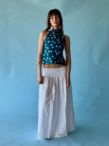 Close-up of halter polka dot crop top and white maxi skirt with elastic waistband