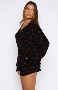 Detail of long-sleeved pajama shirt with red lip print and classic lapel collar buttons