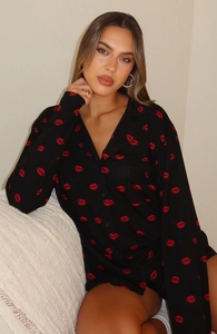 Close-up of women's long sleeve pajama shirt with red lip prints and button-down collar