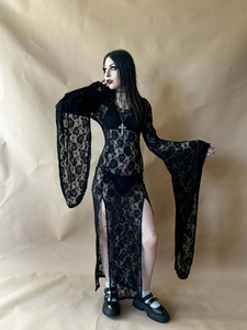 Detail of gothic floral lace long sleeves and side slit on a black slim fit dress