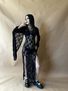 Close-up of black lace fabric details and high slit cut on a Gothic long sleeve dress