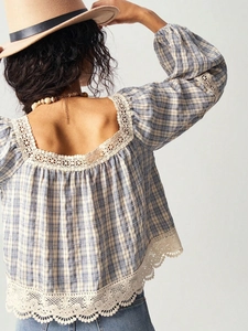 Detail of blue plaid blouse showing exquisite lace trim and puff sleeves at the back