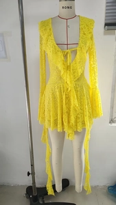 Detailed view of yellow V-neck lace dress with ruffle neckline and flared sleeves