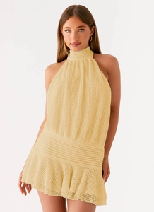Close-up of the delicate hollow crochet knit texture and halter neck detail of this dress
