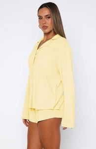 Detail view of the yellow long-sleeve pajamas set with button-down shirt and soft shorts