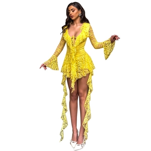 Detail of yellow lace dress featuring deep V-neck, flared sleeves and ruffled lace trims