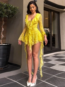 Close-up detail of yellow lace dress featuring V-neckline with ruffled edges and floral texture