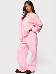 Women's pink two-piece tracksuit with hoodie and matching joggers featuring lace heart patch