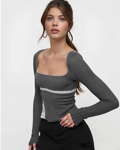 Close-up of grey ribbed long sleeve top featuring white lace trim and square neckline