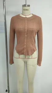 Detail of waffle knit texture and buttoned front on a dusty pink slim cardigan