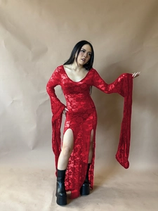 Close-up of red floral lace dress featuring dramatic bell sleeves and side split hemline