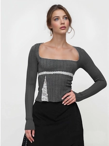 Detailed view of the square neckline with white lace trim and dark gray ribbed fabric