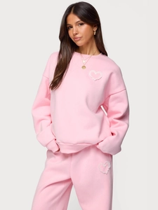 Pink women's two-piece tracksuit with hoodie and pants featuring lace heart appliques