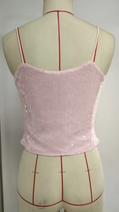 Close-up back view of a pink sequin camisole featuring thin straps and shimmering fabric