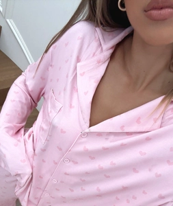 Detail of pink satin pajama set with red heart print and classic button-down collar