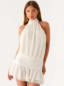 Elegant white crochet halter mini dress with waist cinch and ruffled hem for summer