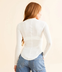 Rear view of white waffle knit long sleeve top with slim fit and curved hem design