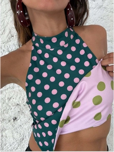 Detail of elegant halter neck top with contrasting polka dot patterns and irregular hem