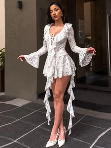 Detail of V-neck lace dress featuring bell sleeves and asymmetrical ruffled hemline