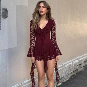 Close-up detail of burgundy lace dress featuring floral patterns and flared long sleeves