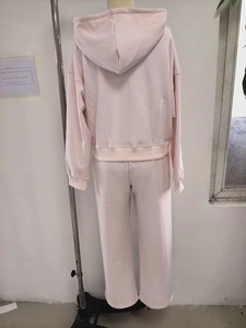 Detail view of pink cotton hooded sweatshirt and wide leg pants loungewear set